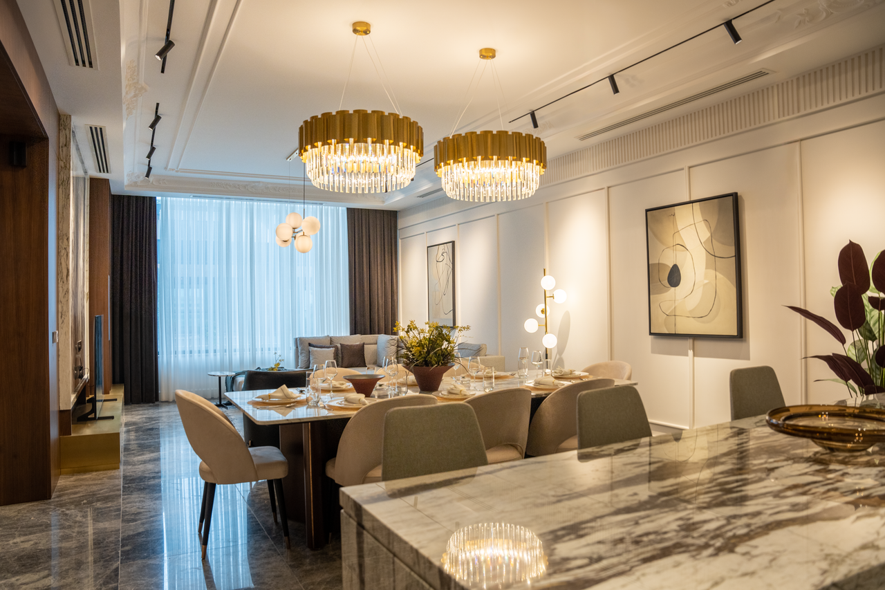 Luxurious dining room with chandeliers, elegant tableware, and modern art.